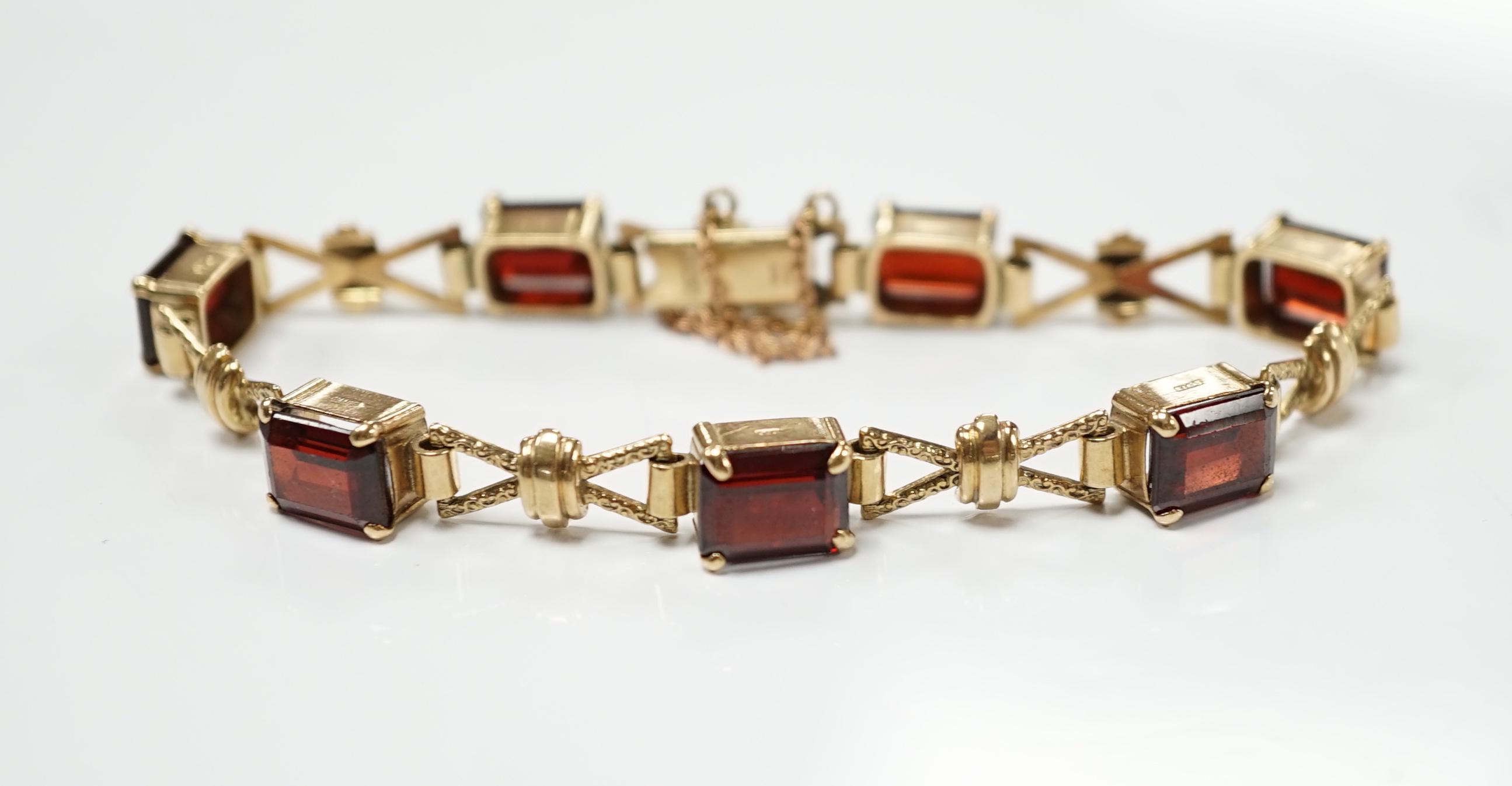 A 1960's 9ct gold and seven stone garnet set bracelet, by Cropp & Farr, 18cm, gross weight 17.9 grams.